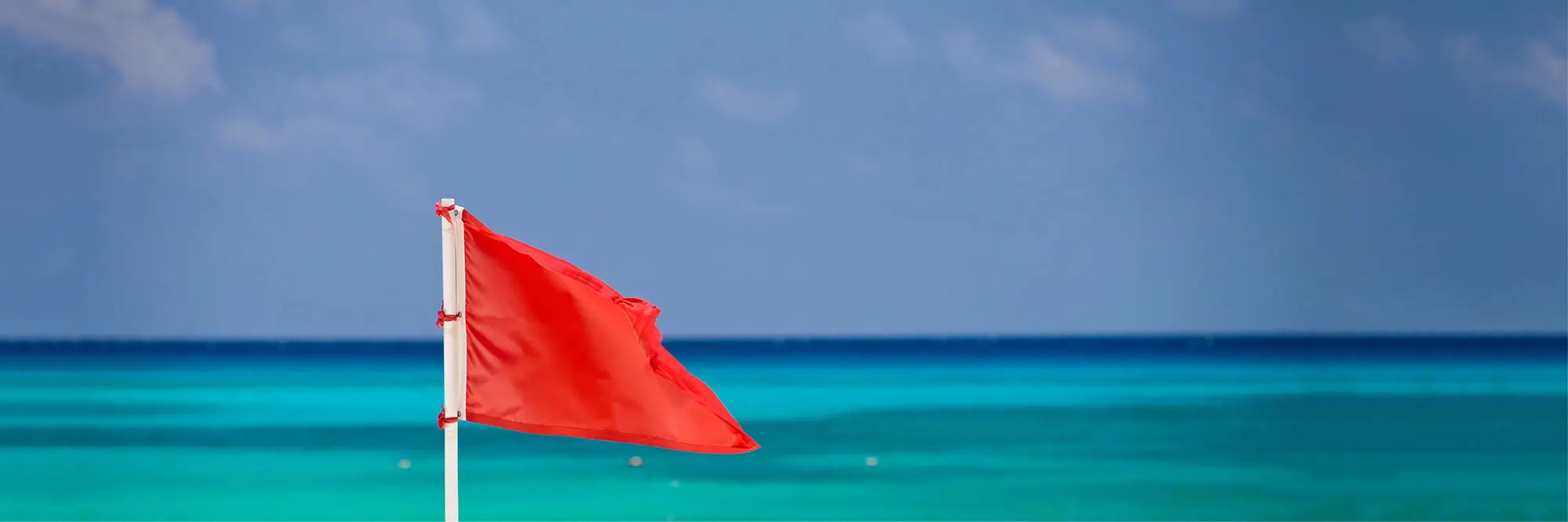 red flag flying at the beach
